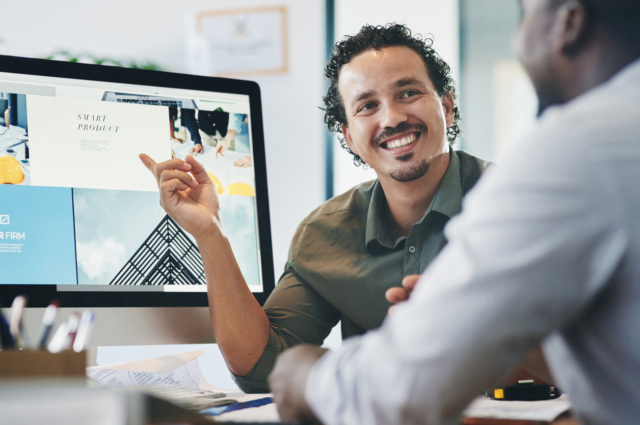 People working on website using a desktop computer